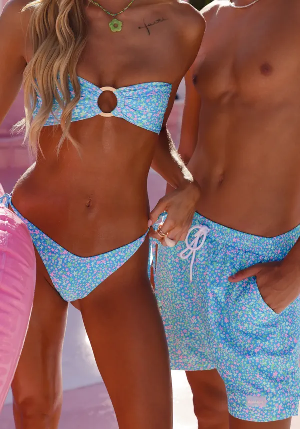 A couple in matching light blue swimwear